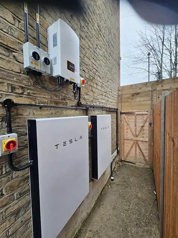 Home battery storage unit wall-mounted in a UK utility room