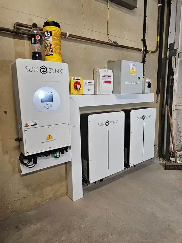 Homeowner checking a battery energy app showing solar, battery and home use